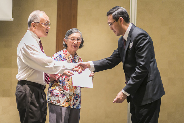 Vice Dean, Prof Chng Chee Kiong (right) welcoming on stage the donors of the Mr & Mrs Wu Jieh Yee Memorial Scholarship, to present the scholarship awards