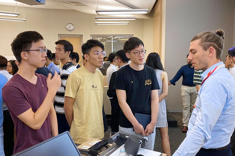 Shizhao (second from right) listening attentively to an industry partner’s sharing