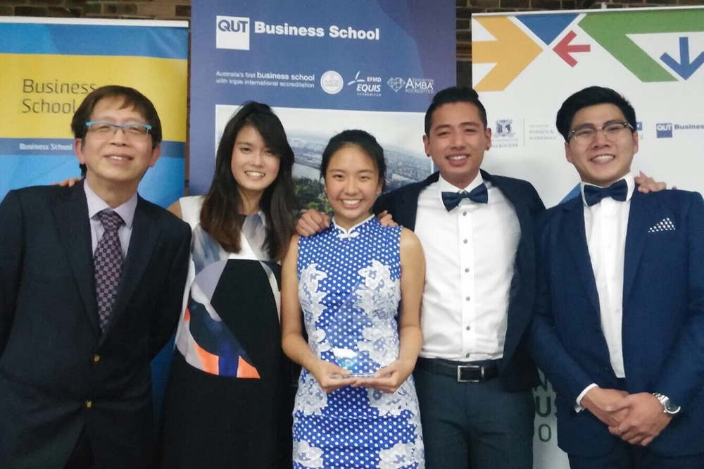 Eugenia (centre) with her teammates at a case competition in Australia