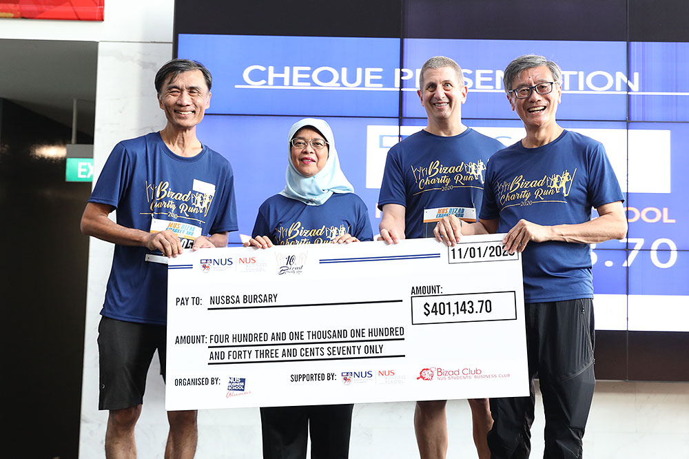 The run raised a record S$400,000 for beneficiaries this year. (From left) BCR 2020 Chairman Mr Chua Hung Meng, President Halimah, NUS Business School Dean Prof Andrew Rose and NUS President Prof Tan Eng Chye presenting the cheque for the NUSBSA Bursary Fund.