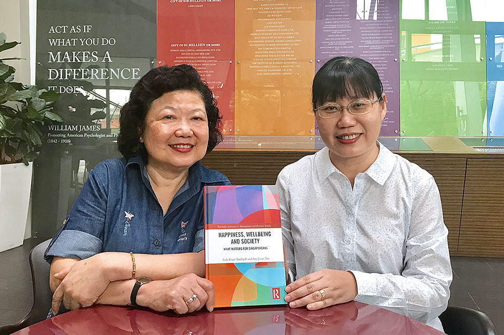 Associate Professors Tan Soo Jiuan (left) and Tambyah Siok Kuan with their latest book