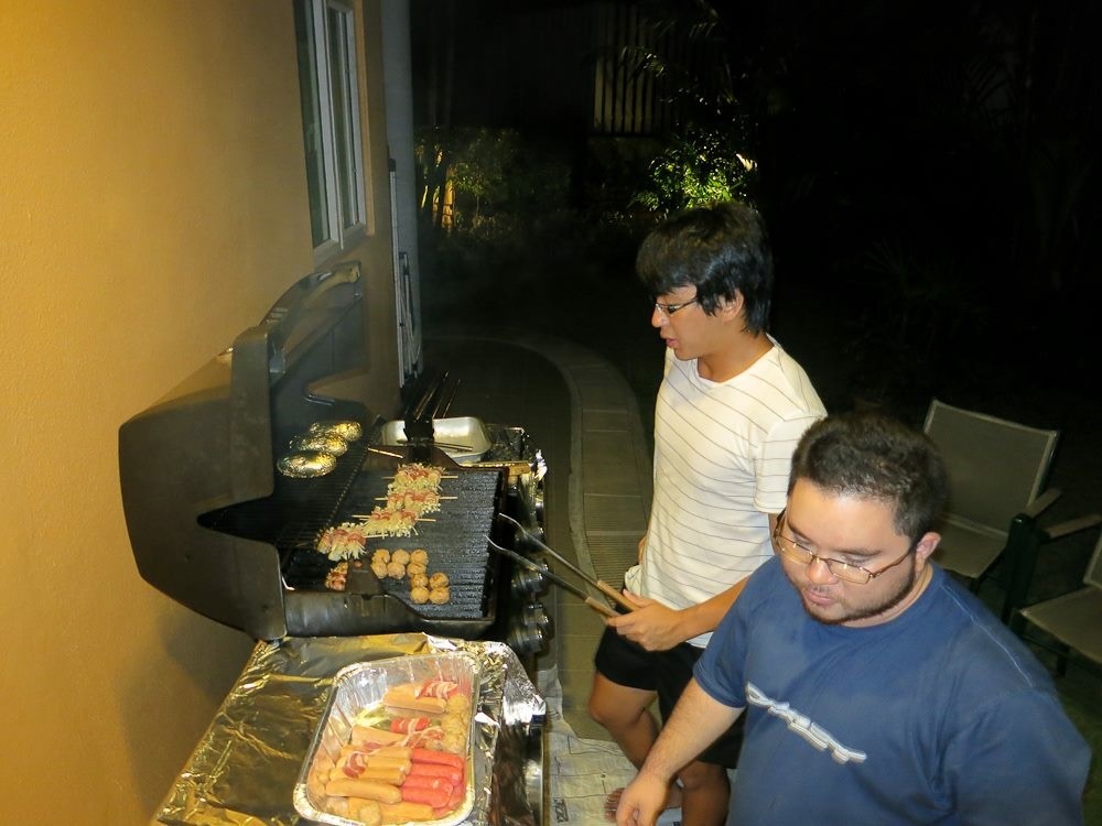 Shane (in striped shirt) barbequeing with university friends for dinner get-togethers