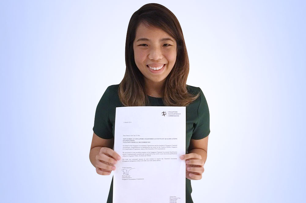 Sheryl with her letter of commendation for doing well in the taxation module. Well done!
