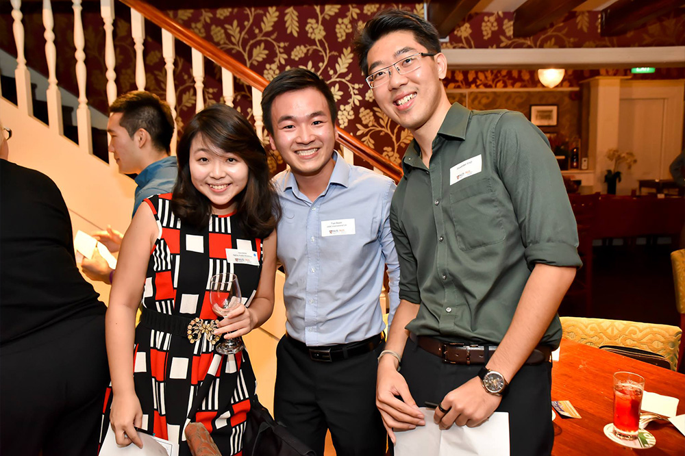 Alexander (right) at an alumni networking event