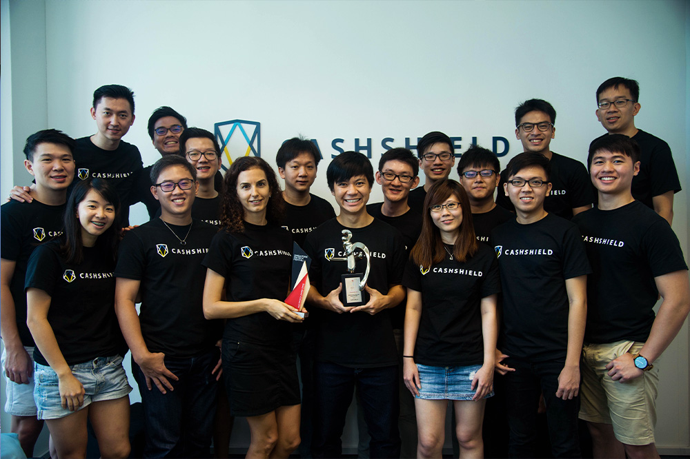The founders: Irene Brime (middle with red trophy), Justin (to her left) and Junxian (middle with trophy) with the CashShield team