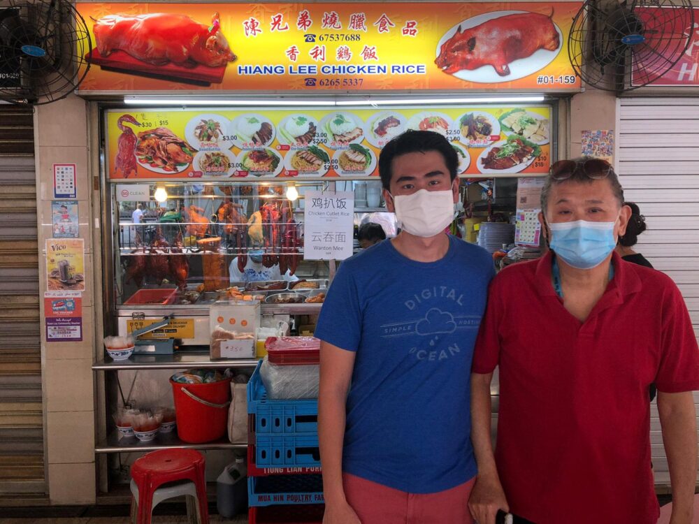 Tan Ying Quan (left) and his father at the family’s chicken rice stall located at Boon Lay Place Market