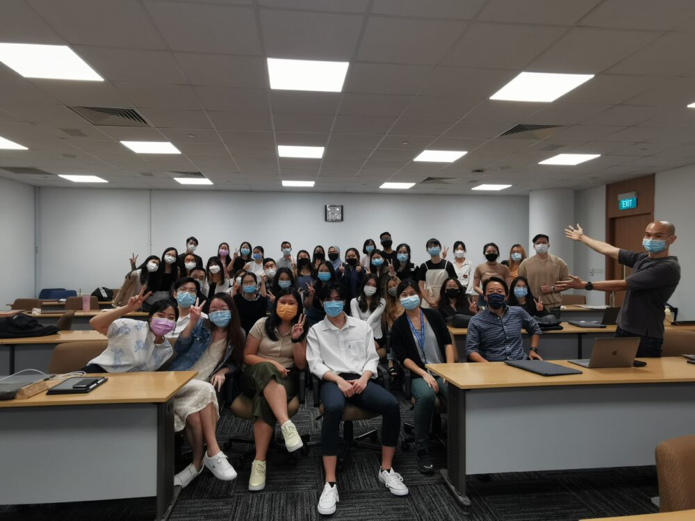 Students pose for a class photo after their final presentations