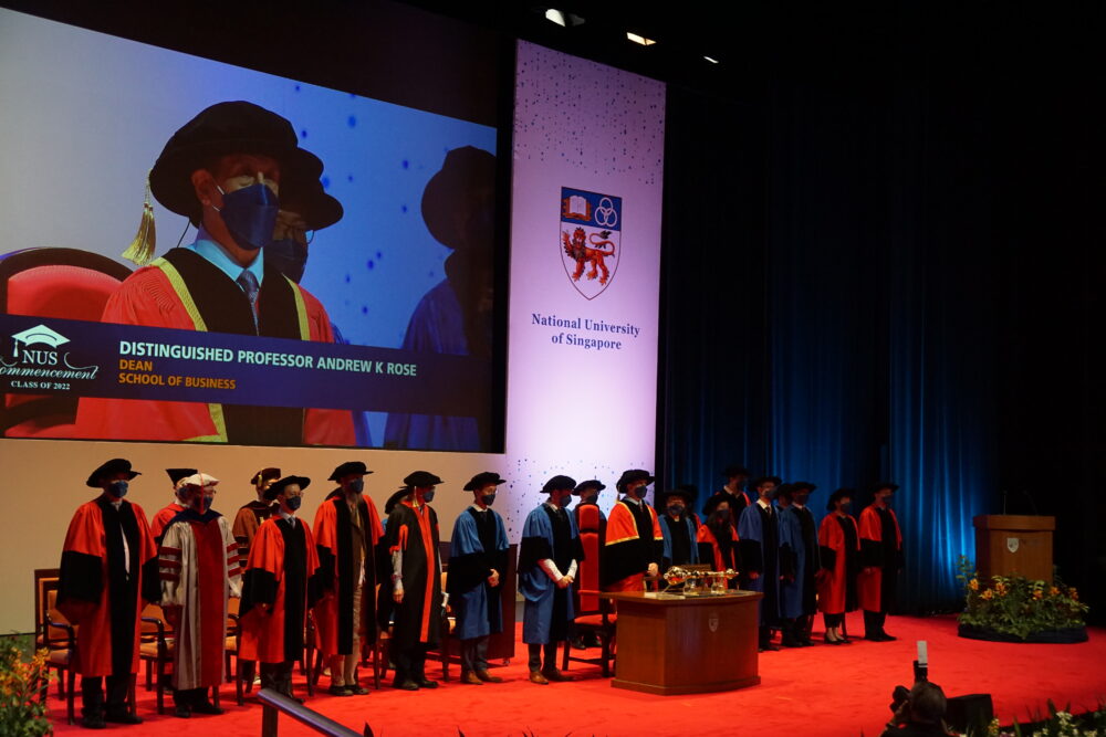 Dean Andrew Rose declaring the commencement ceremony open, flanked by the traditional academic procession comprising faculty members of the Business School