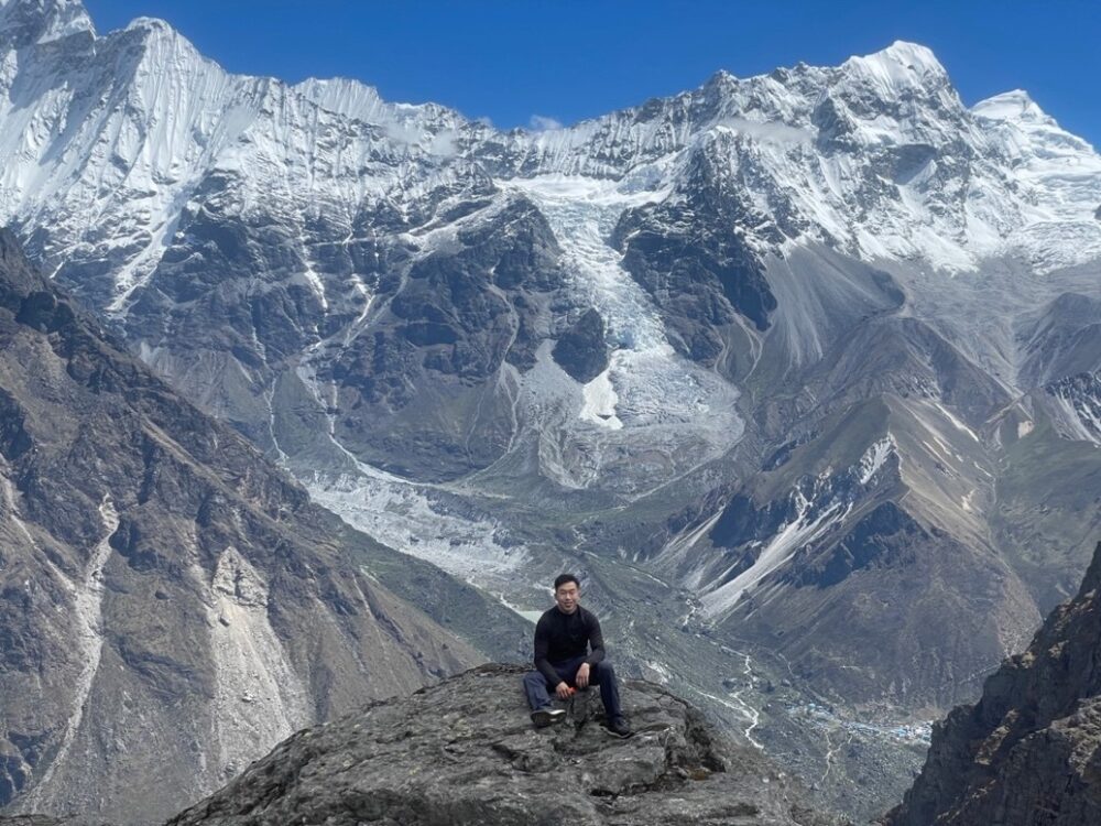 Paul taking a breather against the majestic Himalayan mountains