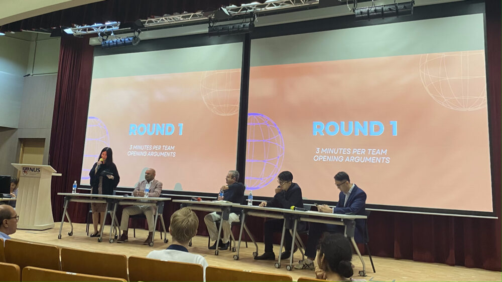 Dr Echo Wang (standing, extreme left) kicked off the debate for the proposition, arguing that the world is already delivering on the kind of technological, political, and social innovations necessary to combat climate change.
