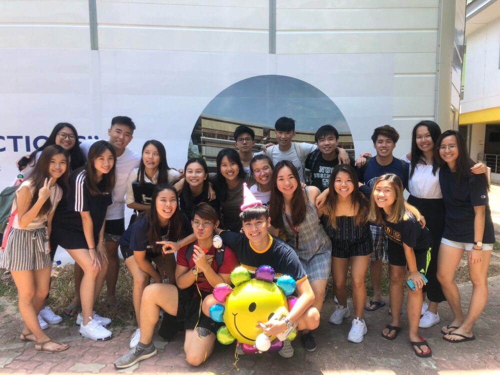 Carissa (back row; third from left) posing with her BIZ School peers at the annual NUS Rag and Flag event